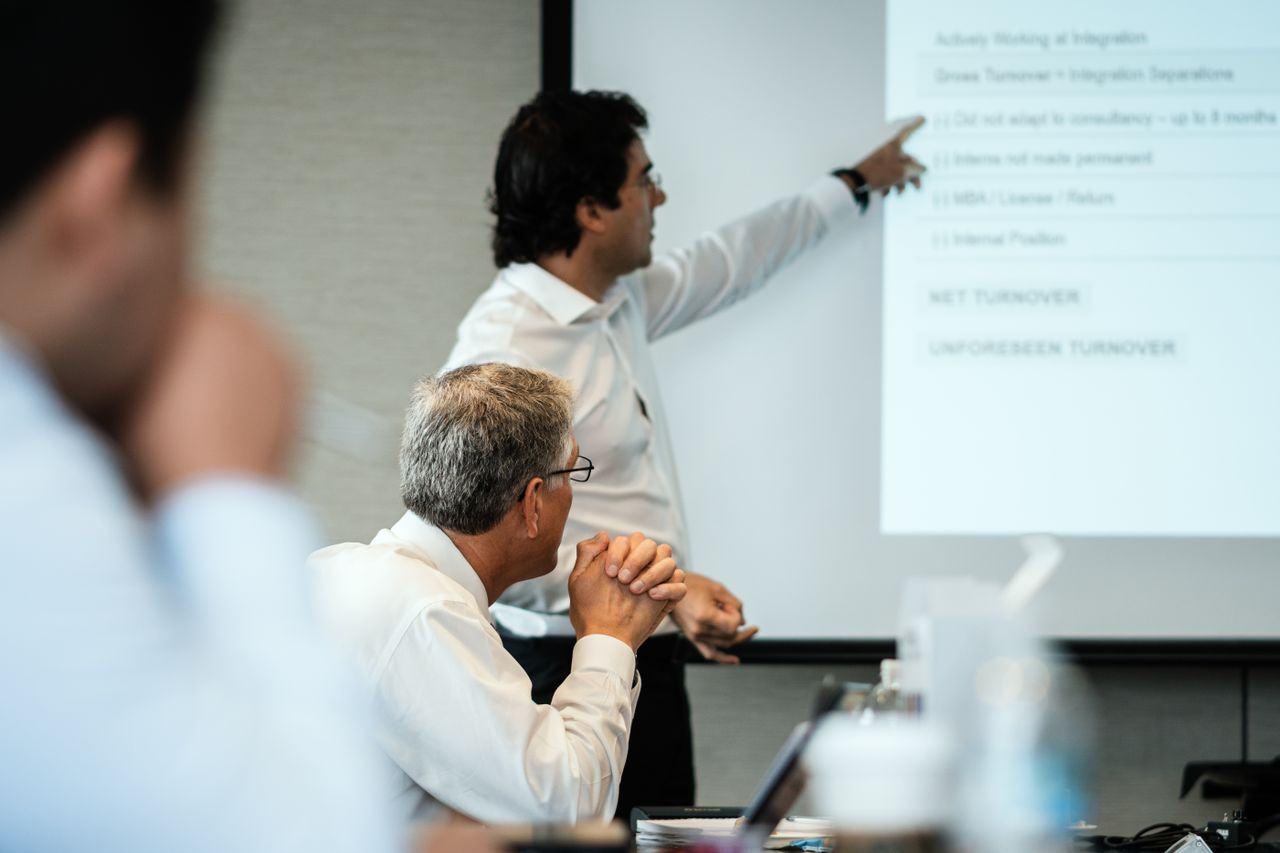 Professional setting with team members focused on a business presentation. Ideal for corporate themes.
